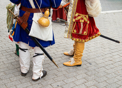 Participants show traditional costumes during Moros y Cristianos festival in Spain with boots and swords