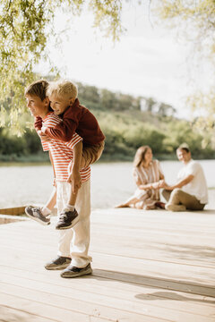 Joyful moments by the lake with family on a sunny afternoon