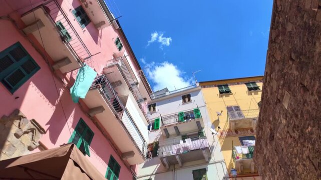 Colorful facades with balconies and hanging laundry. Corniglia, Cinque Terre, Italy