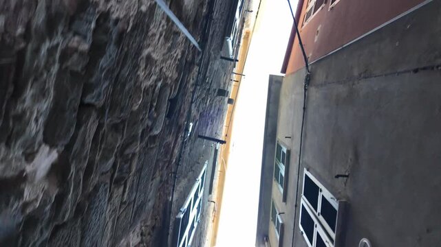 Narrow italian alley viewed upward between old buildings