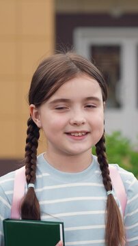 schoolgirl girl looking camera smiling, happy smile eyes schoolgirl face, child kid with book hands walking from school lessons, smile face little child kid schoolgirl girl, happy girl smile teeth kid