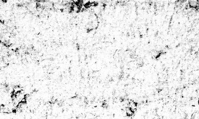 Fototapeta premium Scattered dark fragments and faint lines form a sparse monochrome printed texture.
