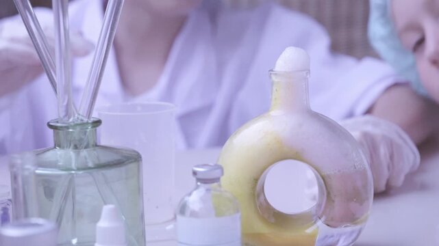 Foaming liquid demonstrating chemistry experiment, Children in protective gear, Young students prepare for hands-on lab work, scientific discovery and mixing chemical solutions
