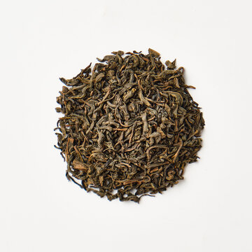 Dried loose leaf green tea on white background