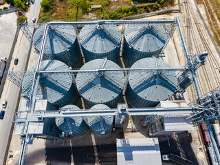 Grain silos and loading equipment viewed from above in an agricultural area © DSMT