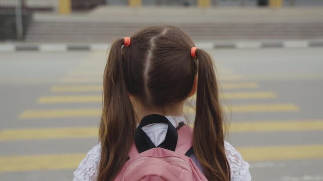Back to school, Girl crossing the street, Pink backpack, School day morning, Safety first, Walking to school, Student on crosswalk, Childhood memories, New school year, First day excitement, Little