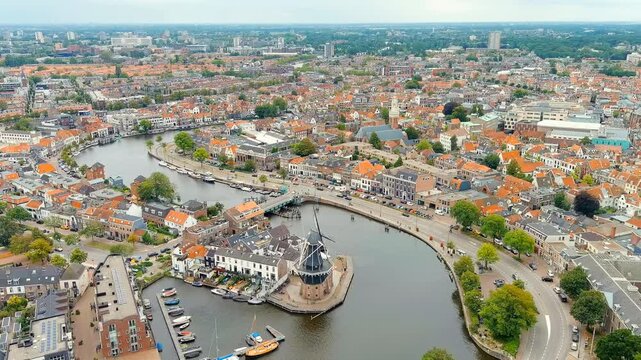 Haarlem, Netherlands. Windmill De Adriaan (1779). Windmill from the 18th century. Panoramic view of Haarlem city center. Cloudy weather during the day. Summer. Drone footage