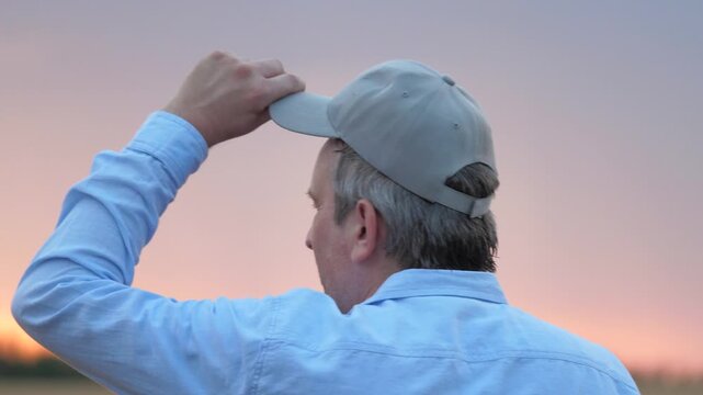 agriculture, wheat field, golden wheat farm field sunset, close up face male farmer wearing cap sunset, farmer walking through wheat field adjusting cap, mosquitoes flying near farmer face, man nature