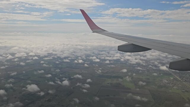 Airplane Wing above Clouds during Descent to Buenos Aires