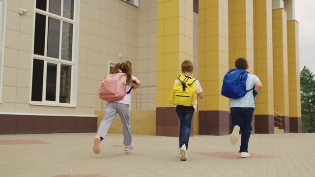 First day at school, Energy and happiness, Kids ready for new challenges, Walking to school with confidence, Backpacks full of dreams, School entrance ahead, Friends keeping pace, Childhood adventures