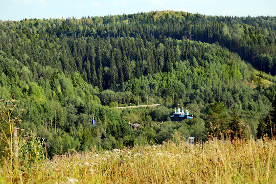 View of the taiga with churches on a clear sunny day, Perm region. Sights of Russia, World tourism.