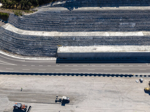 Aerial view of a highway construction site with heavy machinery, earthworks, and retaining walls in Istanbul, Istanbul, Turkiye.