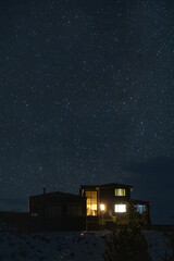 Fototapeta premium Modern house under a starry winter night sky