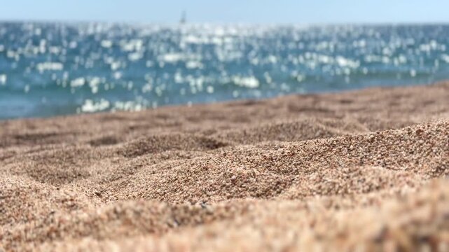 Beautiful sea view, seaside, summer beach, blinking lights in water, waves. Mediterranean beach, coast line, nature. Ocean Landscape background, vacation, travel concept. Selective focus on sand 