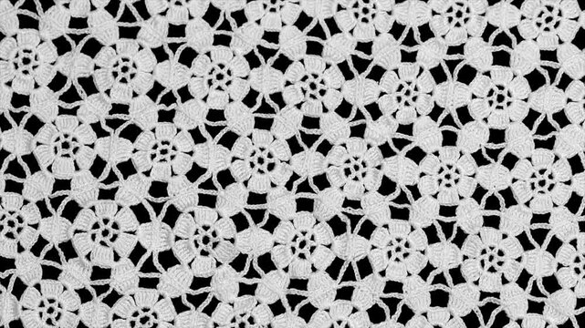 Crochet lace patterns border, crocheted Grandma's Doily, detail of hand-crocheted embroidery, tablecloth, napkin isolated on black background border art design. Craft, vintage linen. Flat lay 
