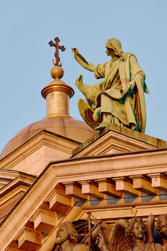 Bottom view on St. Isaac Cathedral at sunset under clouds in Saint-Petersburg, Russia, the apostle with the cross, bas reliefs