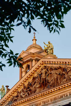 Bottom view on St. Isaac Cathedral at sunset under clouds in Saint-Petersburg, Russia, the apostle with the cross, bas reliefs