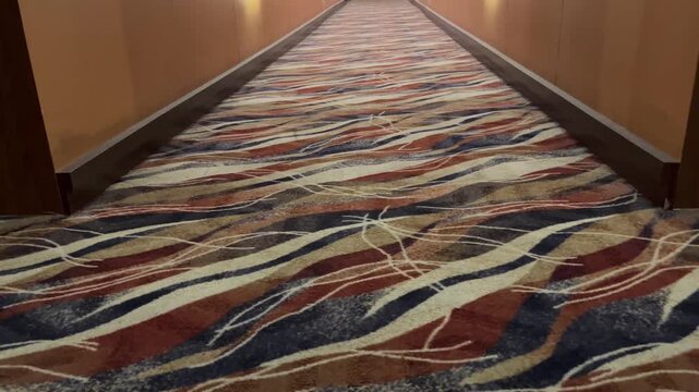 Dimly Lit Hotel Corridor with Decorative Carpet Flooring