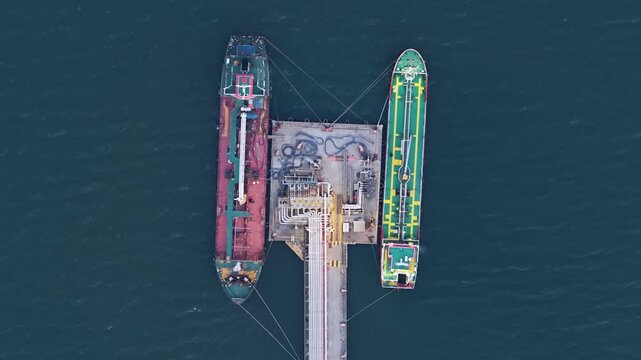 Aerial view of oil tankers docked at a sea port getting fueled