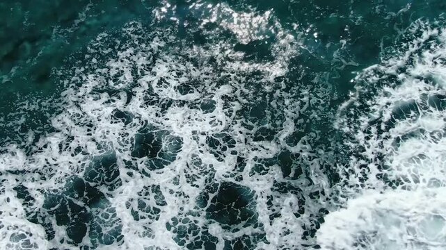 Aerial view of crashing ocean waves, turquoise sea water surface, tropical ocean background, angle summer sea motion