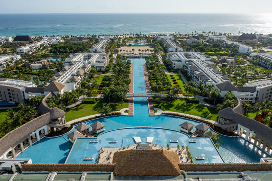 Aerial view of Hard Rock Hotel and Casino Punta Cana with swimming pools, tropical gardens, and modern architecture along the coastline in Punta Cana, La Altagracia, Dominican Republic.