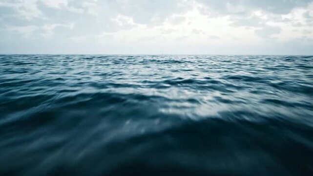 Calm ocean waves surface view at twilight, serene deep blue sea horizon background, water
