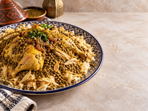 Traditional moroccan rfissa served on a decorative communal platter with shredded msemen chicken lentils and rich fenugreek broth presented for a warm family style meal at home gathering