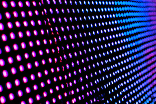Macro photograph of an RGB subpixel grid array on a modern LED television display, showing