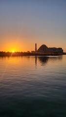 Naklejka premium Sunset at Losari Beach with 99 Domes Mosque in Makassar, Indonesia