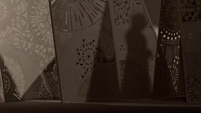 Decorative perforated panels create patterned shadows in a warmly lit interior