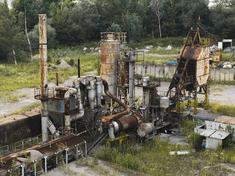Aerial view of abandoned industrial machinery and rusted processing equipment in a former industrial facility
