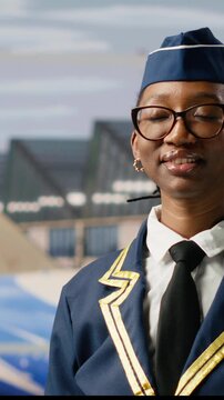 Vertical screen: Woman flight attendant walking at airport with suitcase