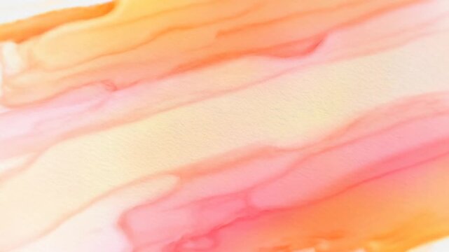 Watercolor paint spreads into soft pink and orange abstract shapes on white paper