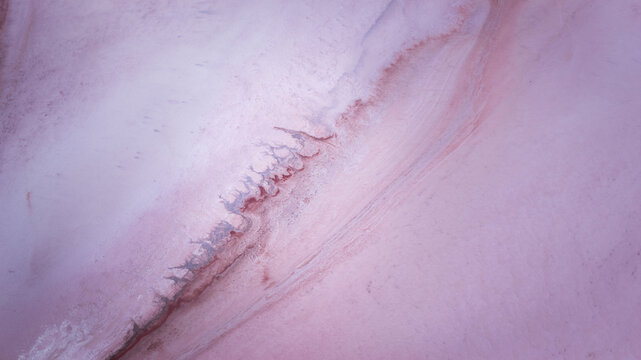 Aerial view of Hutt Lagoon Pink Lake showing abstract pink patterns and vibrant salt lake textures in Yallabatharra, Western Australia, Australia.