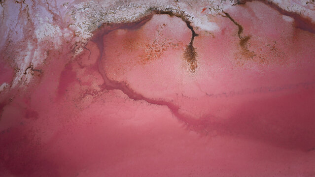 Aerial view of the abstract pink patterns and salt crust textures of Hutt Lagoon Pink Lake in Yallabatharra, Western Australia, Australia.