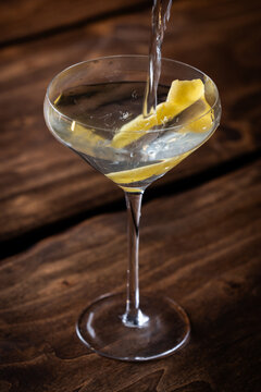 Pouring a classic Vesper Martini in to a martini coupe glass with a slow shutter speed showing motion.