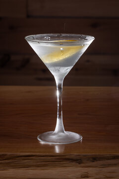 The classic Vesper Martini, served in a tall martini glass on a wooden background.