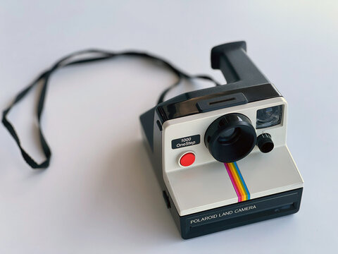 Vintage Polaroid OneStep SX-70 White Rainbow Stripe Instant Film Camera Isolated on White Table