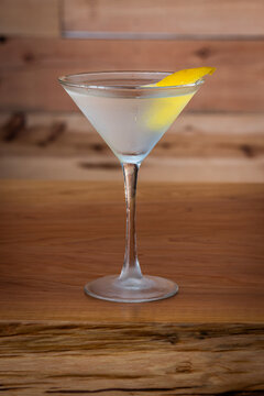 The classic Vesper Martini, served in a tall martini glass on a wooden background.