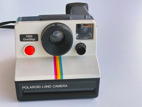 Vintage Polaroid OneStep SX-70 White Rainbow Stripe Instant Film Camera Isolated on White Table