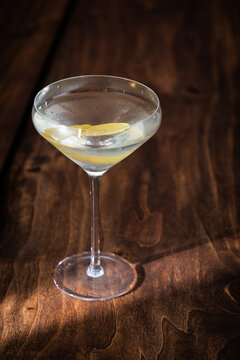 The classic Vesper Martini, served in a modern coupe glass on a wooden background.