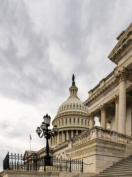 Capitol patriotic skyline in Washington DC clouds. National architecture facade in Washington DC blue sky. Washington government Congress Senate law Washington. Historic democracy symbol.