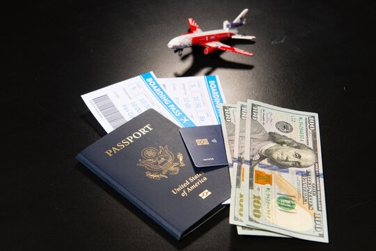 US passport with boarding pass cash and credit card. Travel documents for international trip. American passport and tickets with US dollars for travel preparation. Passport money and for travel.