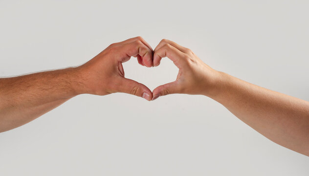 Love connects hands and fingers. Love creates emotional relationship concept. Heart shape represents love clearly. Human gesture symbolizes love closeup.