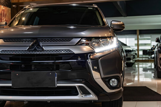 Grey Mitsubishi Outlander SUV Front Headlight Close Up