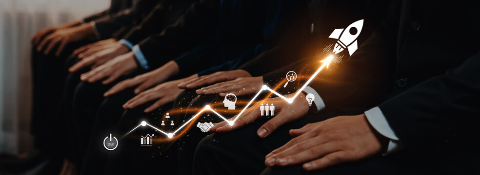 A group of business professionals in suits seated together, symbolizing financial growth with a creative rocket launch graphic and animated graph, representing success and innovation. Trope