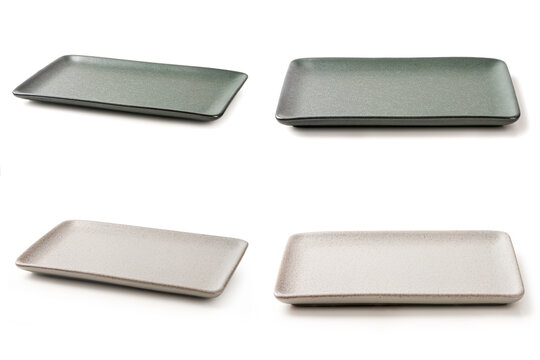 Collection of modern rectangular ceramic trays in dark green and speckled cream white. Minimalist tableware for elegant food presentation, isolated on a white background.