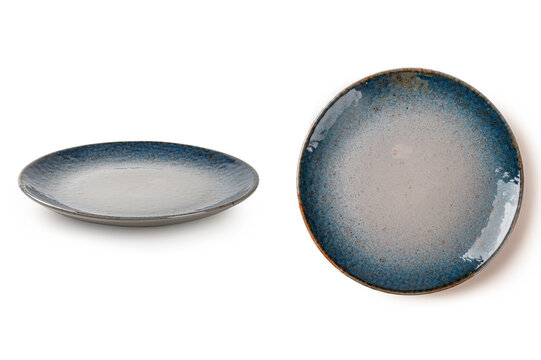 Side and top views of  round ceramic plate with unique blue and sand speckled glaze. Elegant minimalist dinnerware for food styling, isolated on white background.