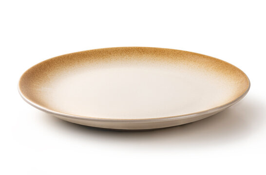 Round ceramic dinner plate with a minimalist beige center and rustic brown speckled edges. Elegant stoneware for professional food styling and presentation, isolated on white.