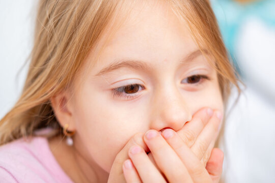 child covering mouth with hands, expressing fear speaking, shyness, social anxiety, struggle begin articulation, expressing silence, suppress cough or sneeze, Childhood shyness and secret keeping